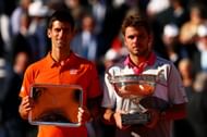 Novak Djokovic (L) & Stan Wawrinka with their trophies after the 2015 French Open final